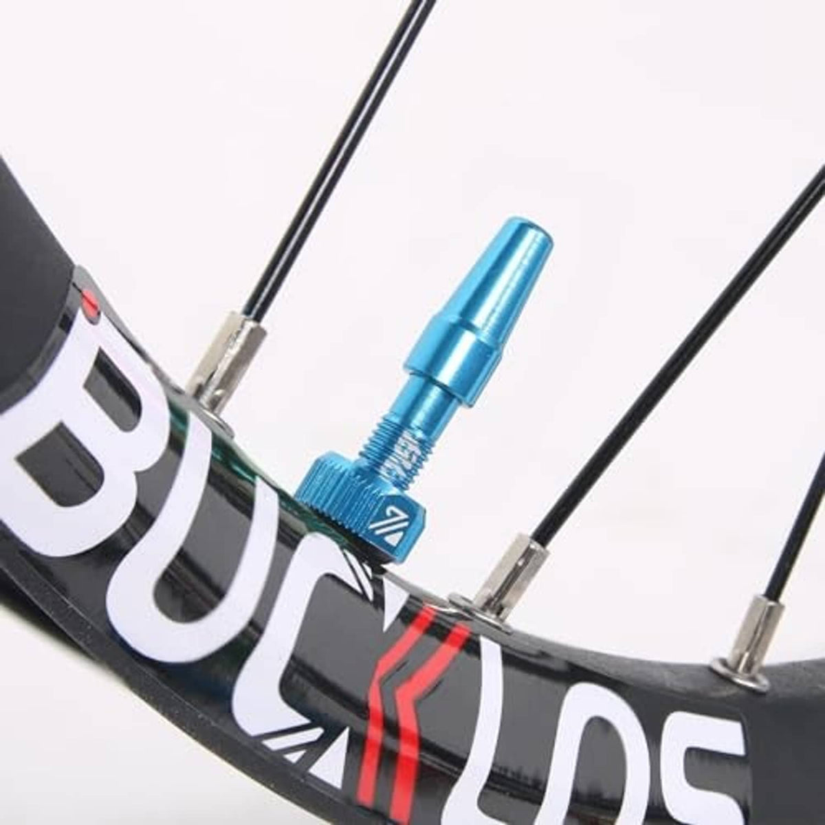 Blue Presta valve stem installed on a bicycle rim