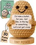 Crochet potato figurine with black bead eyes and smile, standing on wooden base
