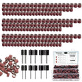 Bulk sanding drums with red abrasive sleeves and metal centers, neatly lined up