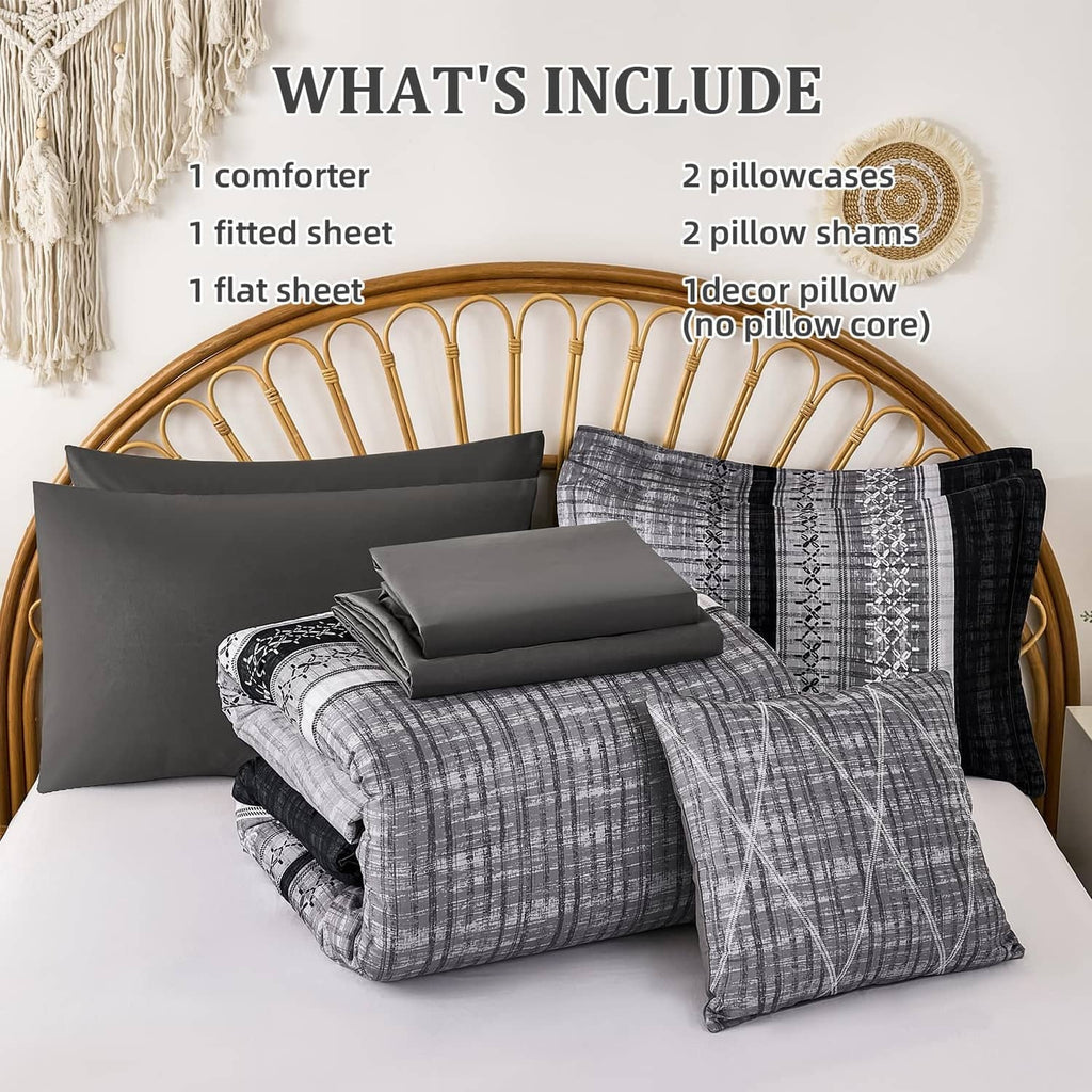 Black and gray comforter set with matching pillow shams and neatly arranged bedding pieces