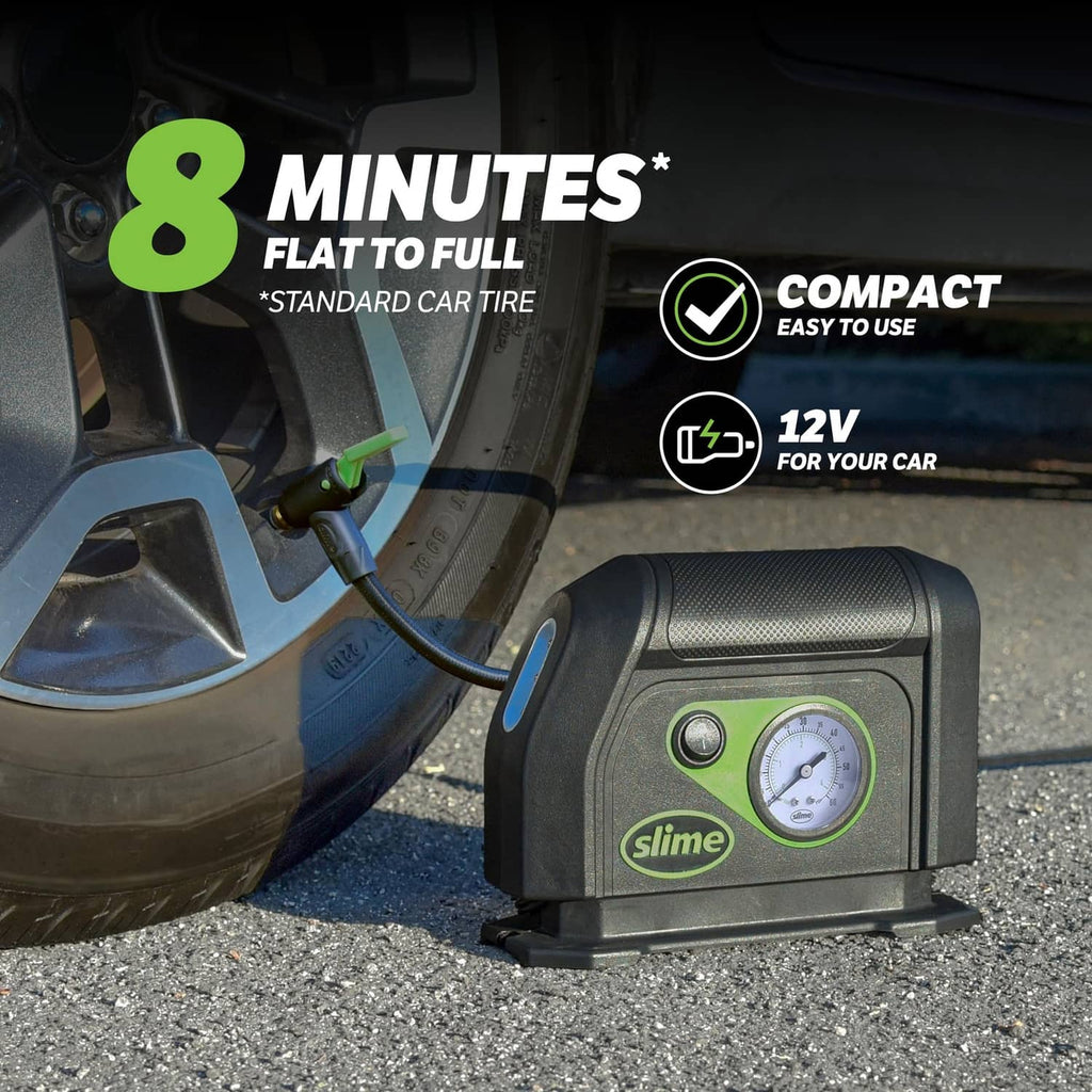 Portable tire inflator with analog gauge and attached hose, shown near a car tire