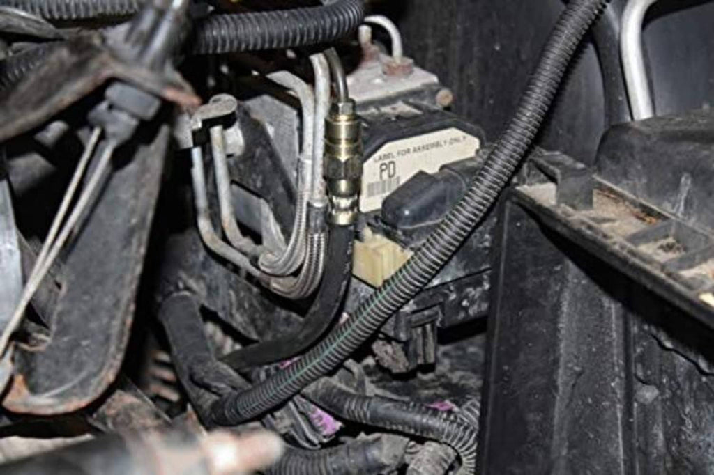 Flexible brake hose installed in an engine compartment with connected metal line