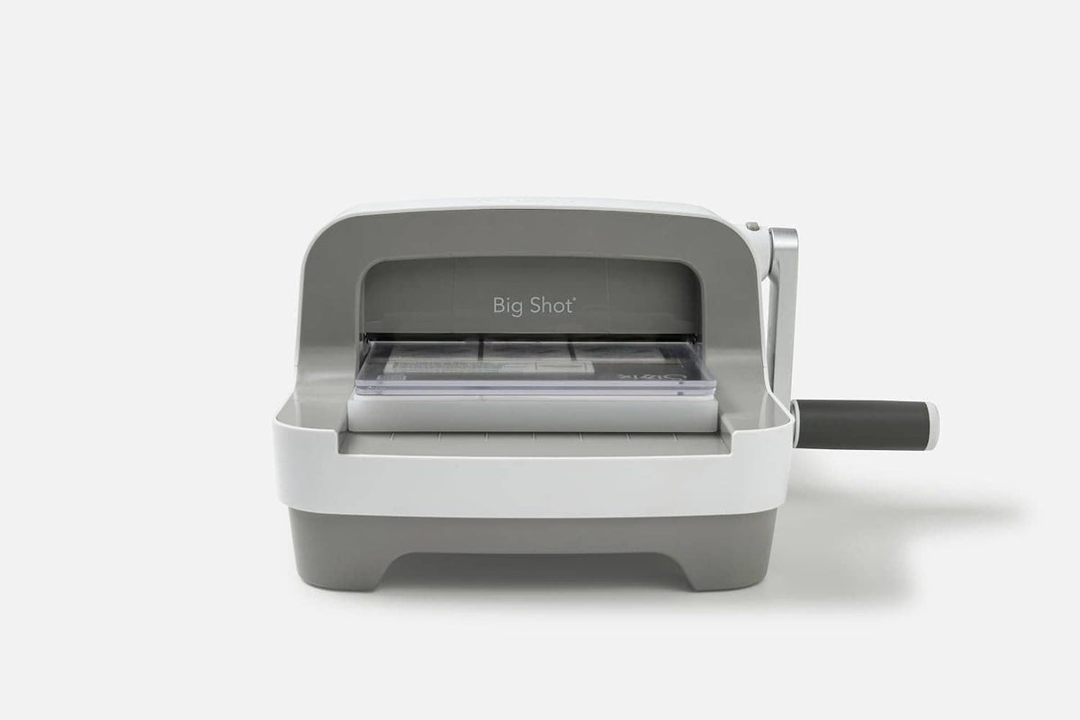 White Sizzix Big Shot die-cutting machine shown front view with handle