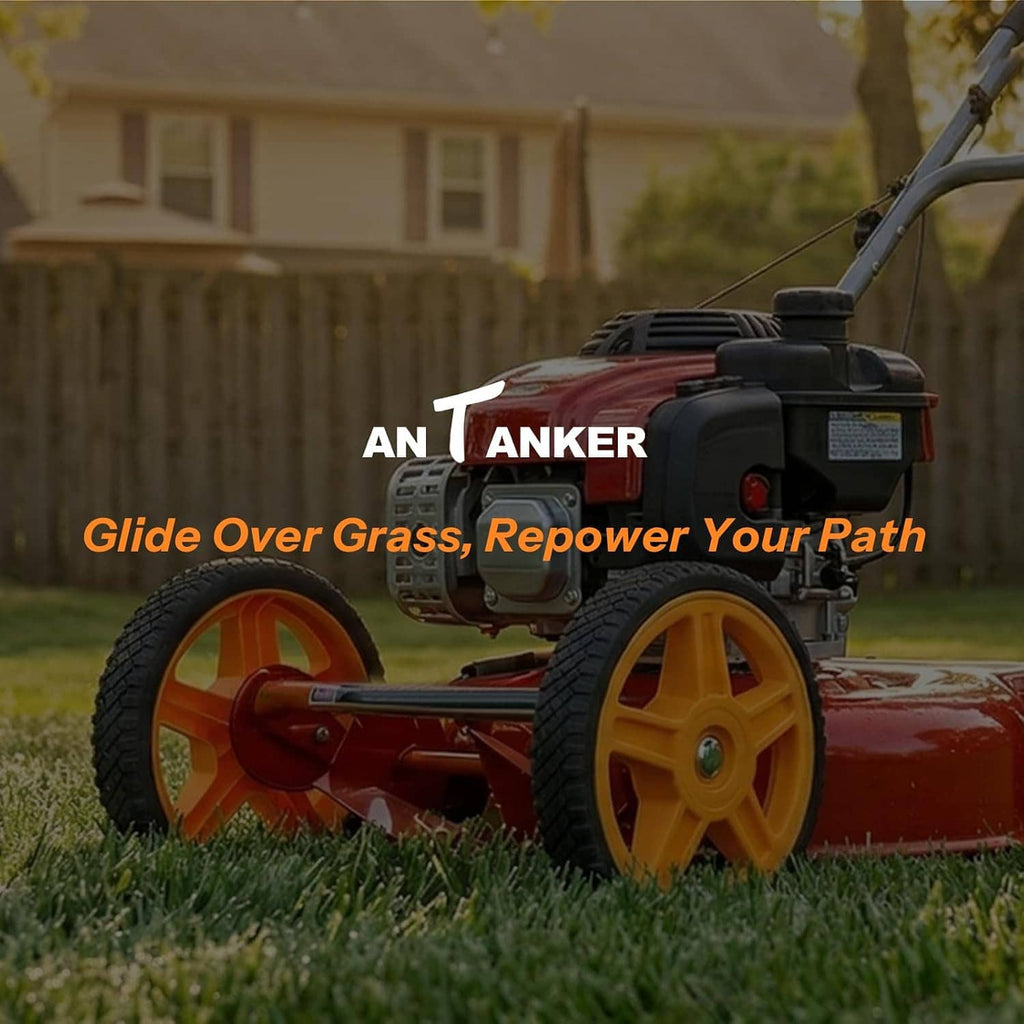Lawn mower with orange wheels and black tires on grass near a yard fence