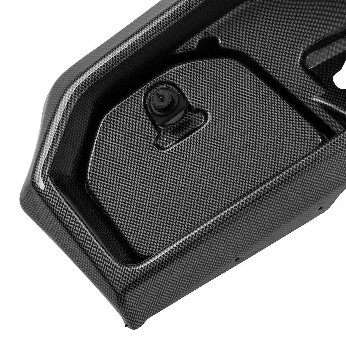 Close-up of dark carbon fiber-style dash cover with textured surface and circular key latch