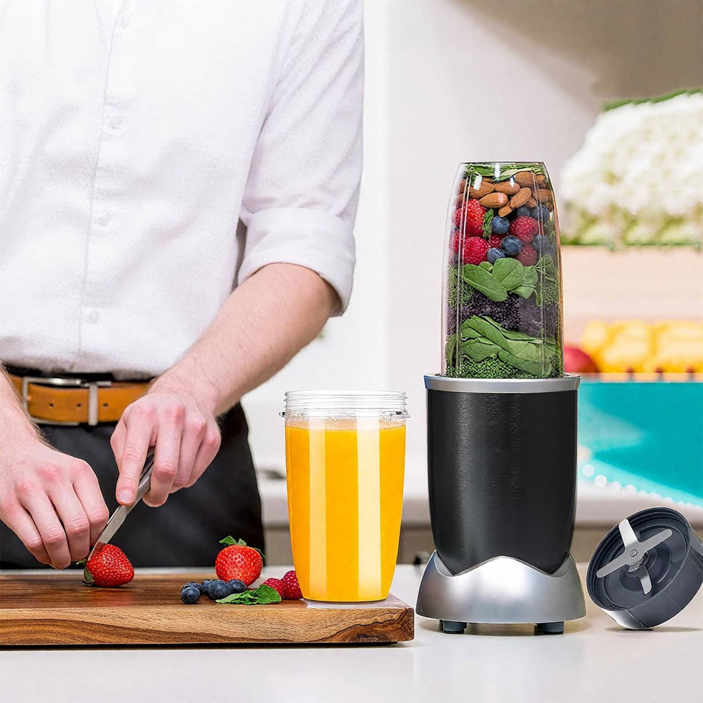 32 oz blender cup filled with juice on countertop with blade base and parts
