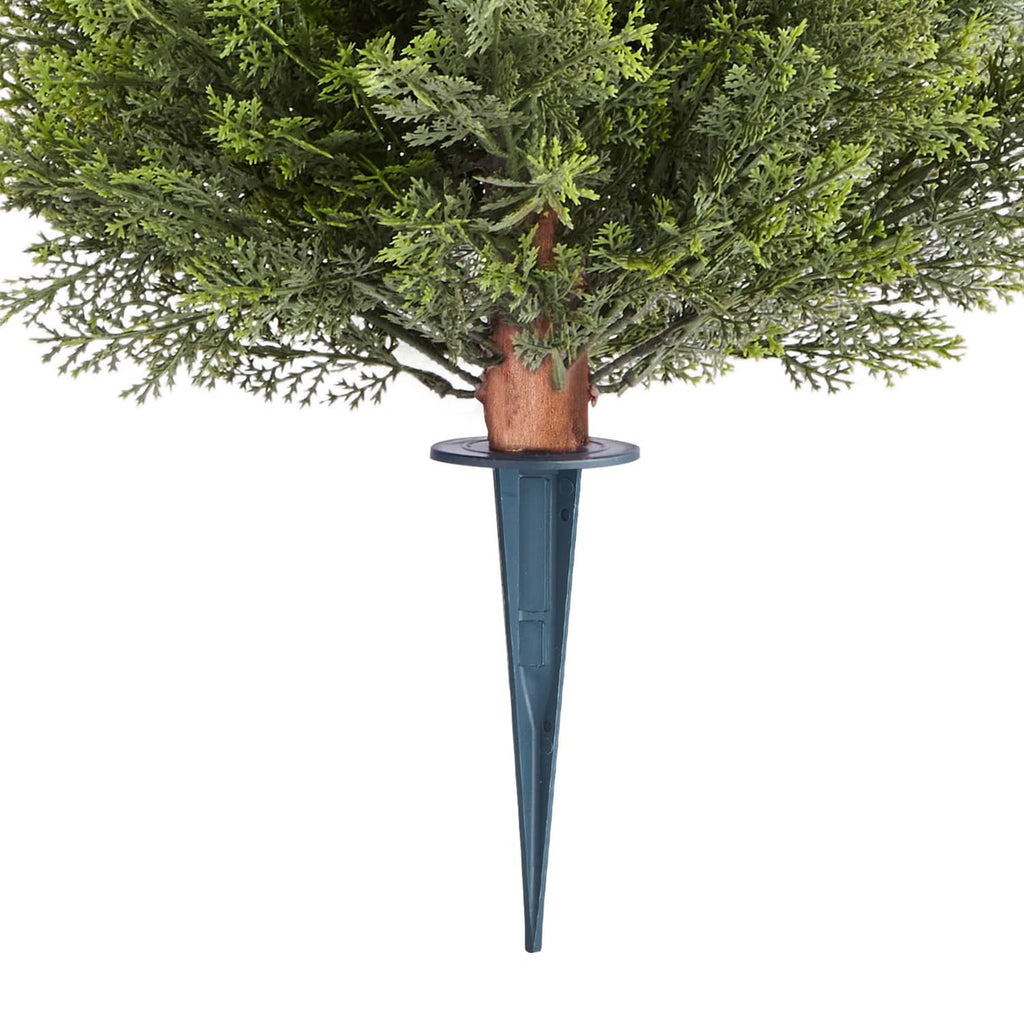 Close-up of artificial cypress topiary trunk with brown bark and blue ground spike base