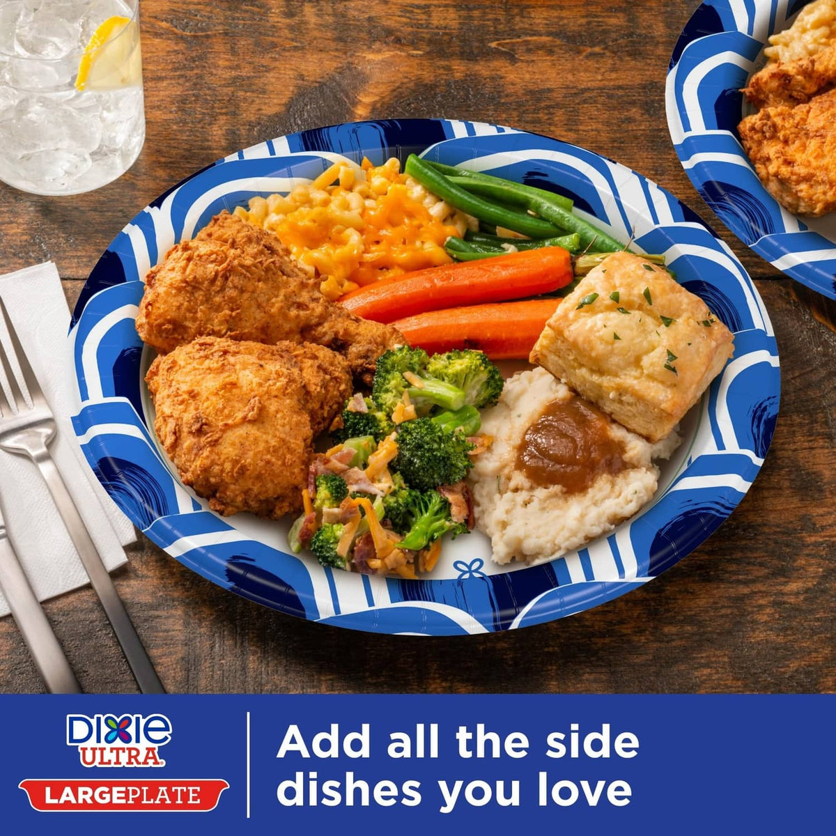 Blue-and-white patterned large paper plate with chicken, vegetables, and sides