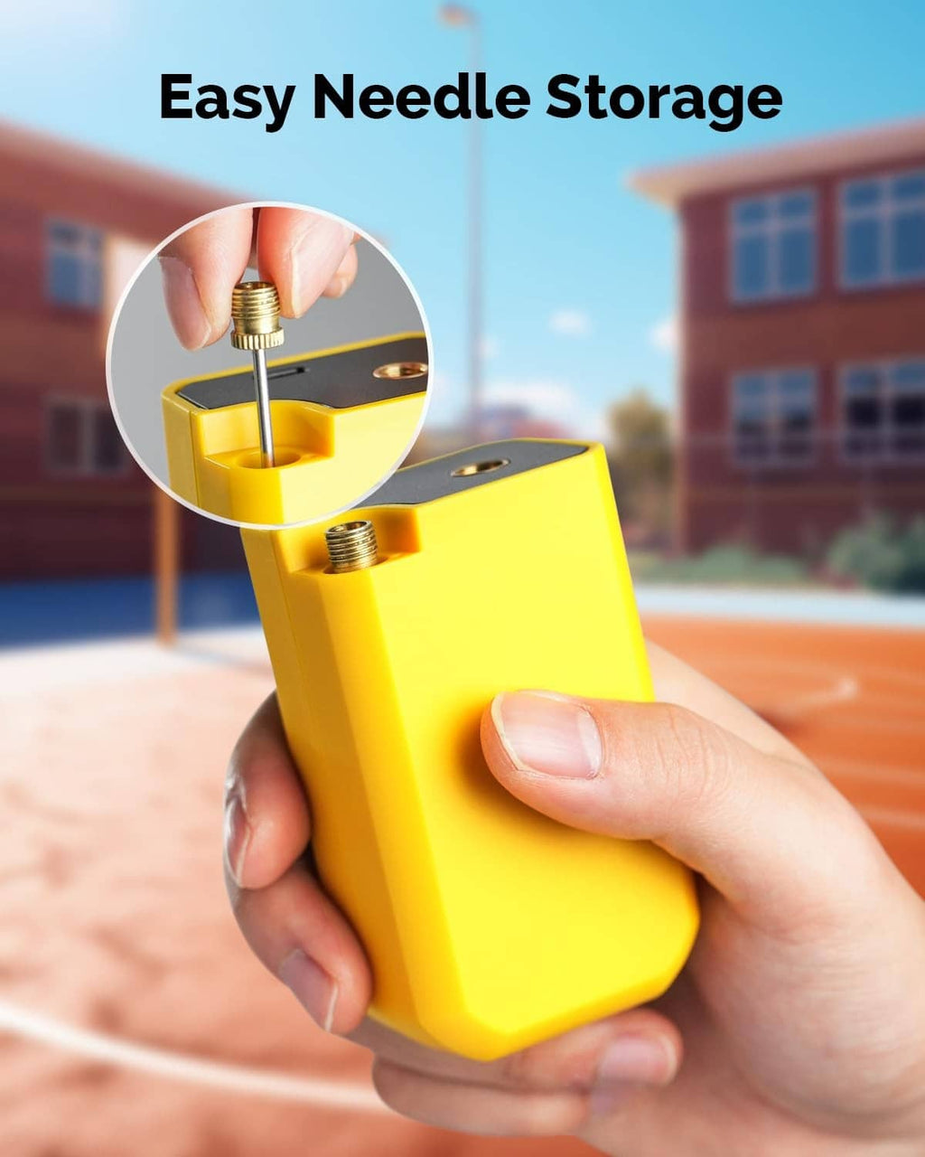 Yellow electric ball pump held in hand with needle stored on the top fitting