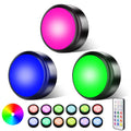 RGB LED puck lights with remote control, shown in blue, green, and pink glow