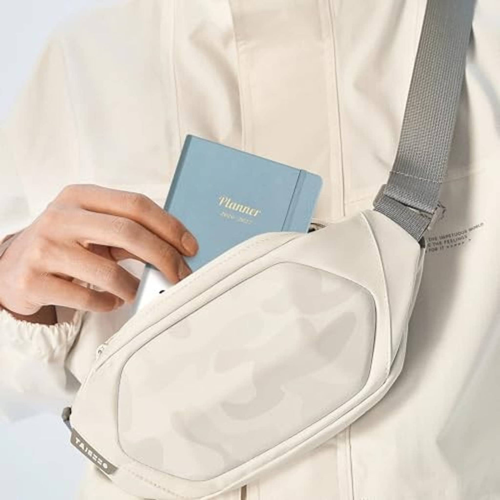 Gray-blue pocket planner calendar in a white sling bag with shoulder strap