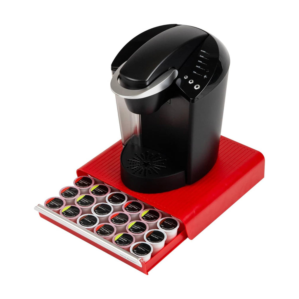 Red pod drawer with organized pod tray next to a black single-serve coffee brewer