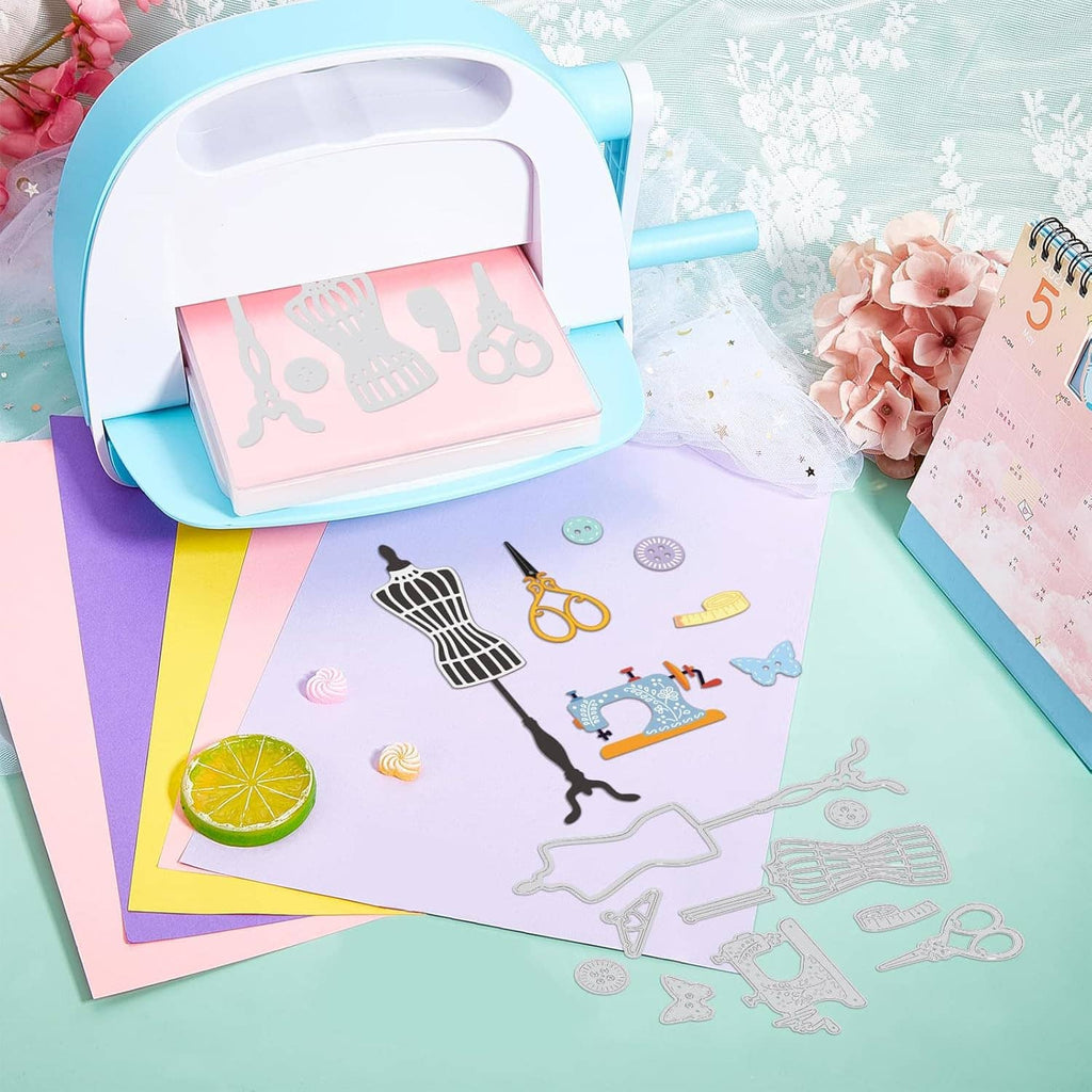 Sewing theme metal dies on scrapbook paper with sewing tools, spools, and butterflies