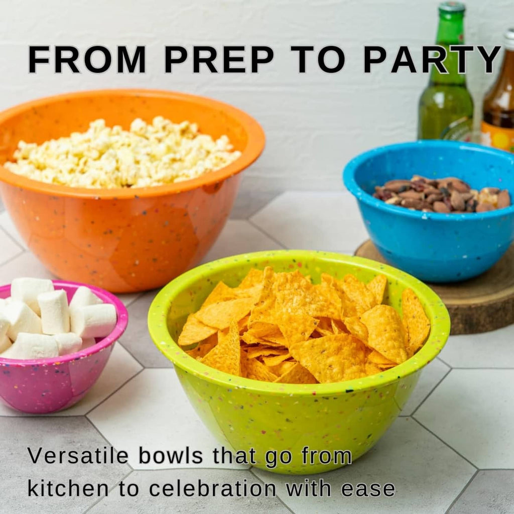 Colorful confetti-speckled mixing bowls with snacks and ingredients on a countertop