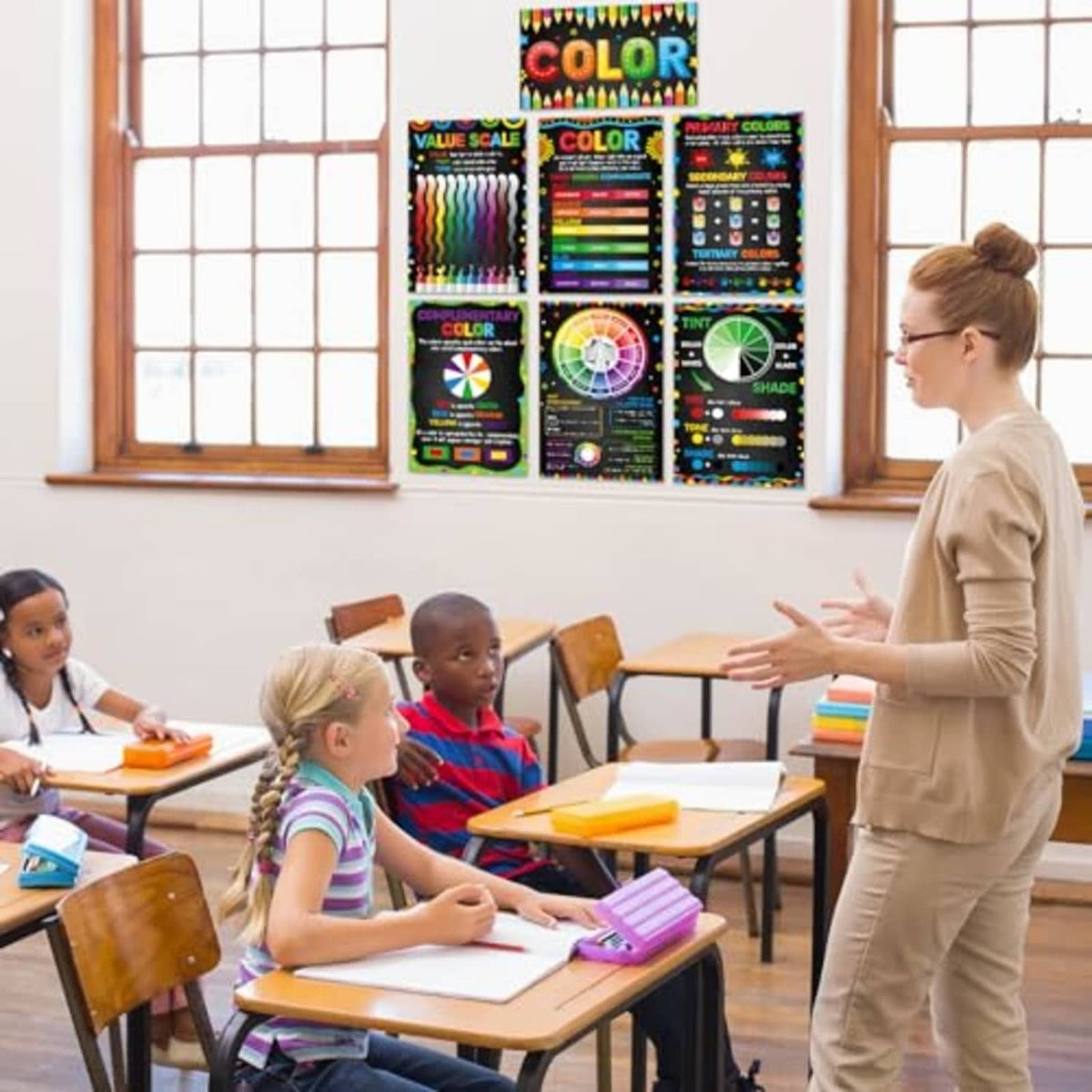 Color theory poster set mounted on classroom wall above student desks