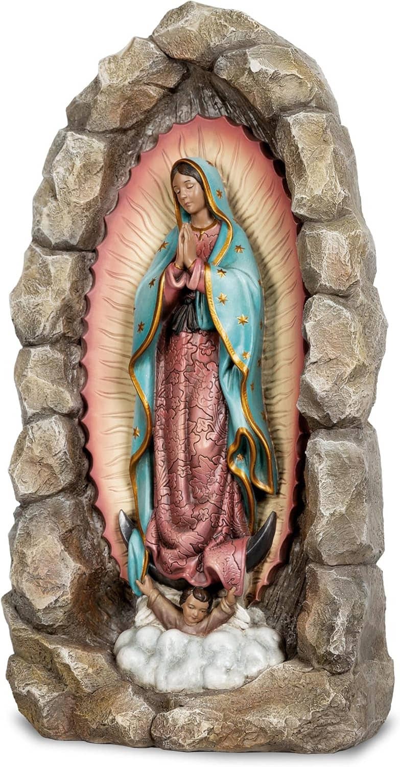 Virgin Mary statue in rocky frame, teal mantle with gold stars, pink inner halo over clouds.