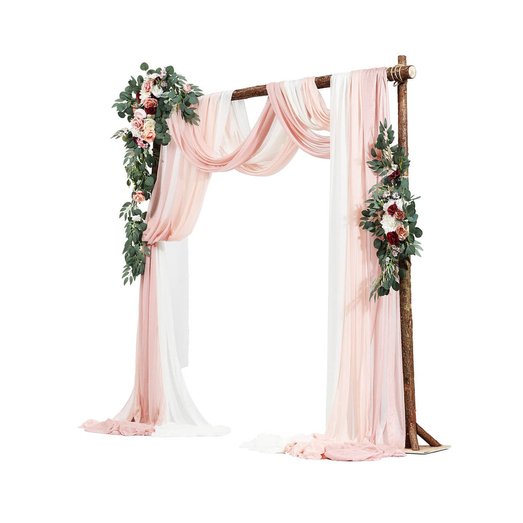 Pink wedding arch with sheer drapes and artificial floral corner garlands on wooden posts