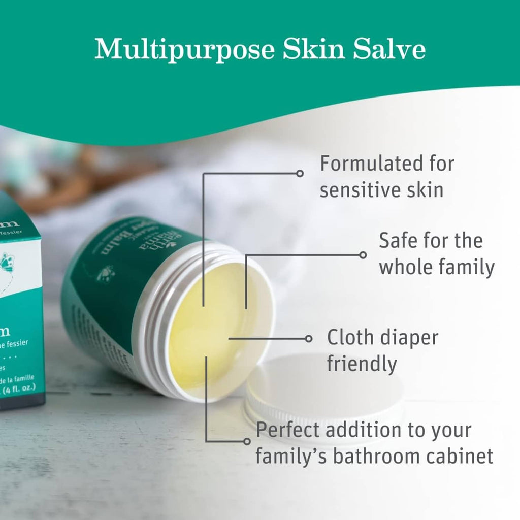 Open organic diaper balm jar with pale yellow balm in white container, silver lid