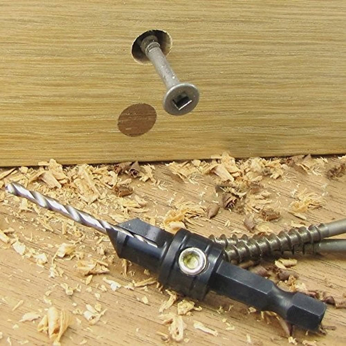 Countersink drill bit in holder making a beveled hole in wood