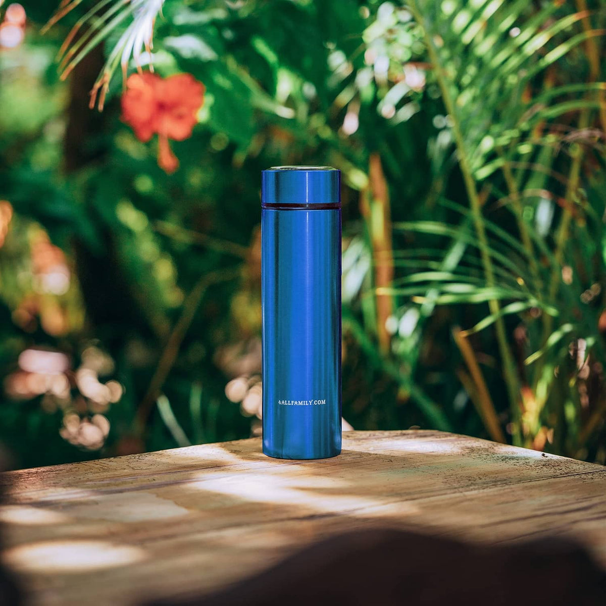 Blue insulin travel cooler case standing outdoors on a wooden surface
