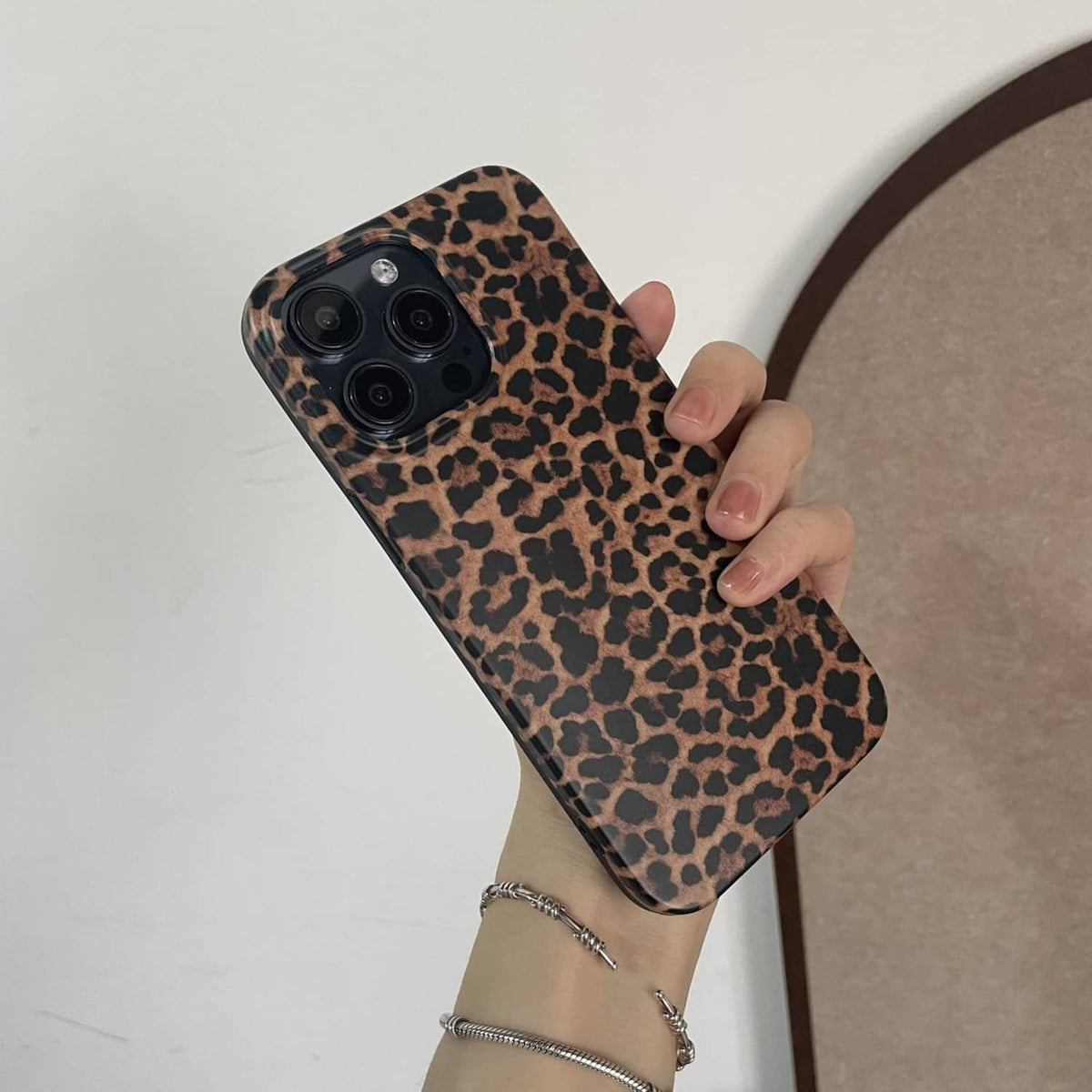 Brown leopard print phone case with camera lenses and protective raised corners