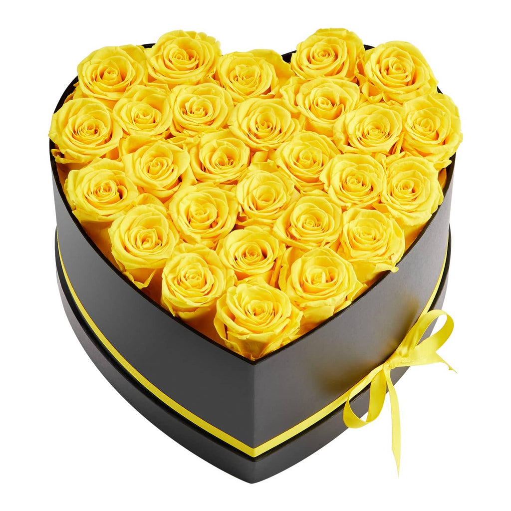 Yellow preserved roses in a heart-shaped black gift box with yellow ribbon