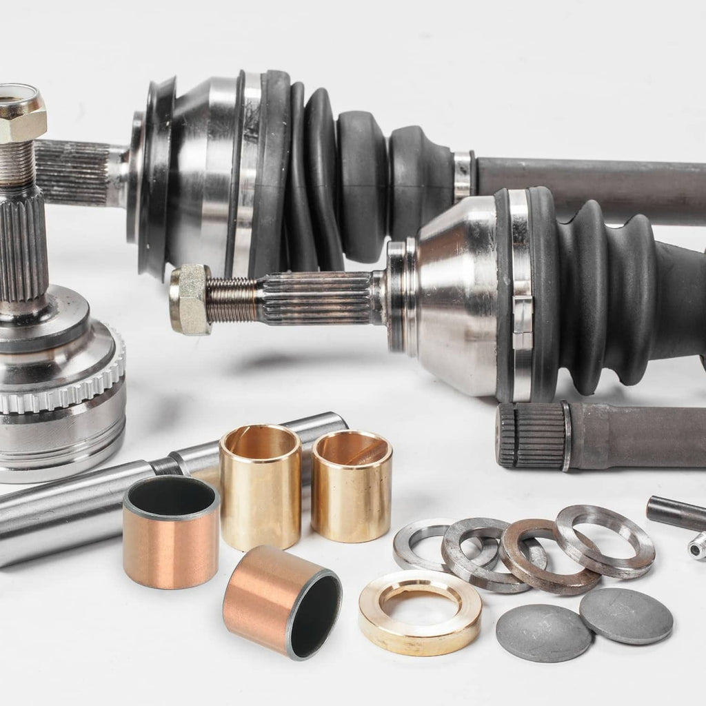 Brass sleeve bearings with black-lined bores, shown with mechanical parts
