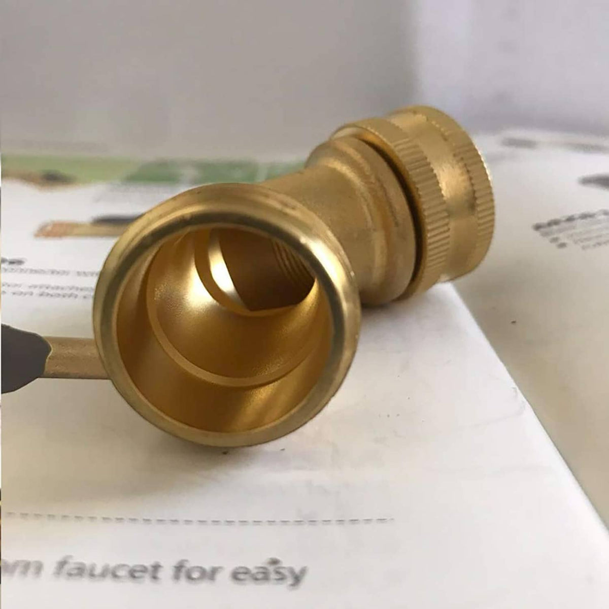 Brass 45-degree hose elbow connector end view with internal hex fitting