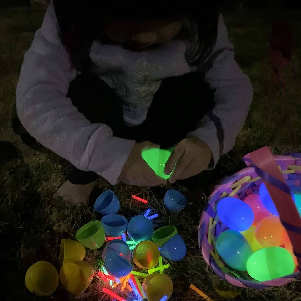 Mini glow sticks and a child playing outdoors, glowing green, blue, red, and yellow