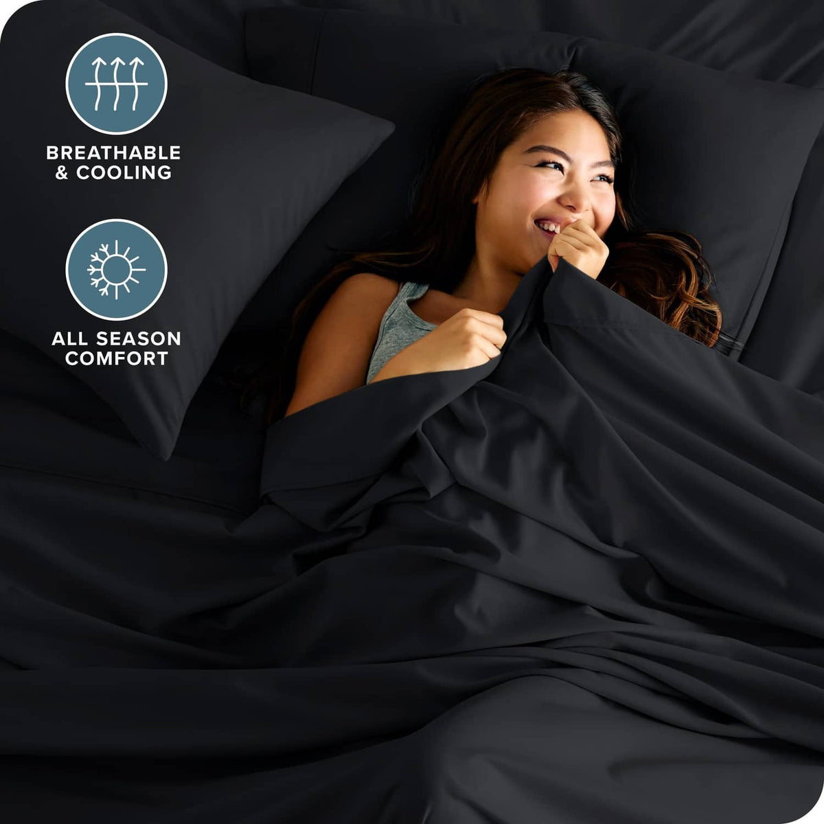 Black bed sheets with two matching pillowcases, smooth drape and folds