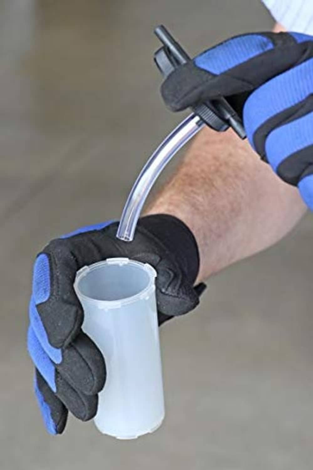 Gloved hands using a hand pump brake bleeder with a clear collection cup