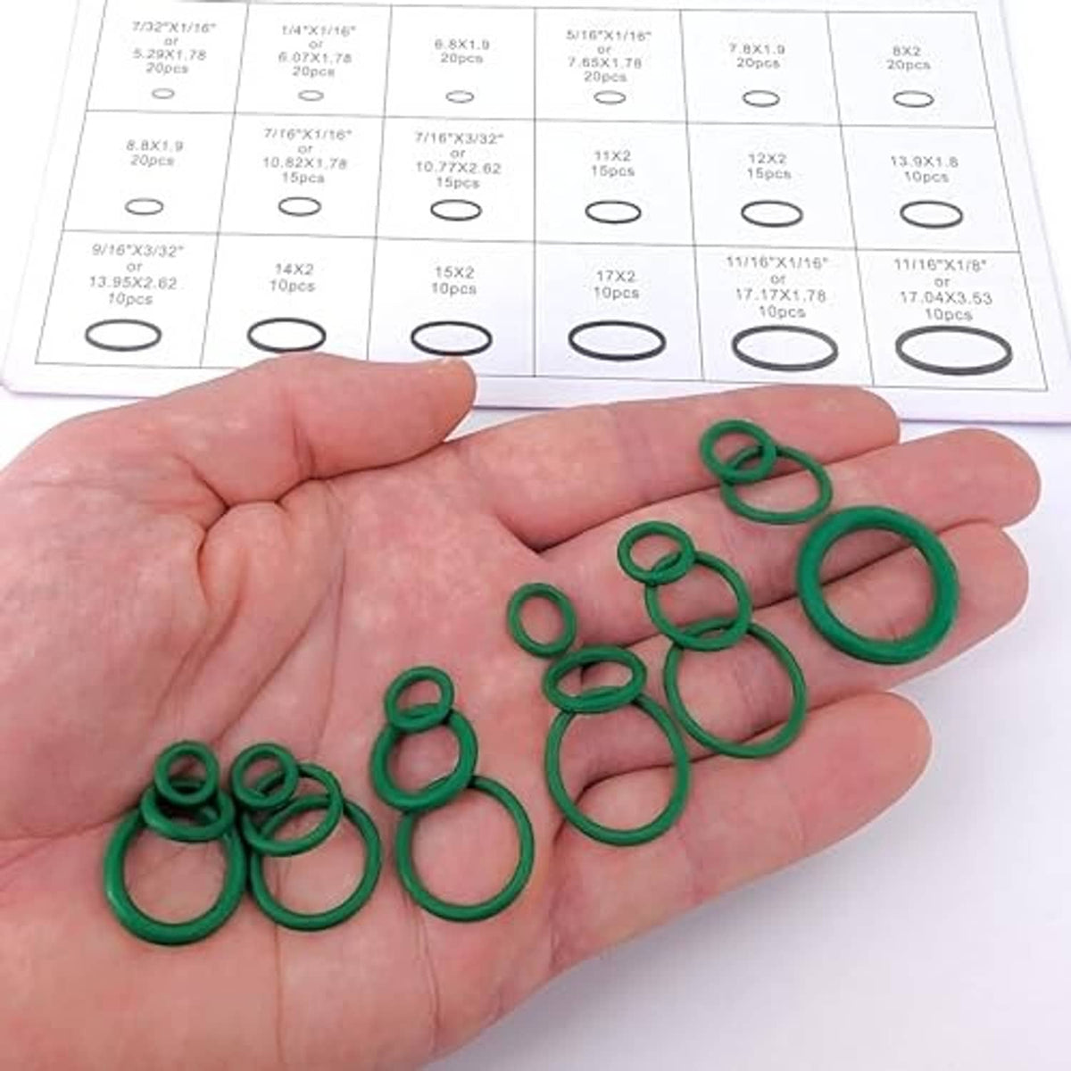 Green O-ring seals for A/C valve cores held in a person’s hand
