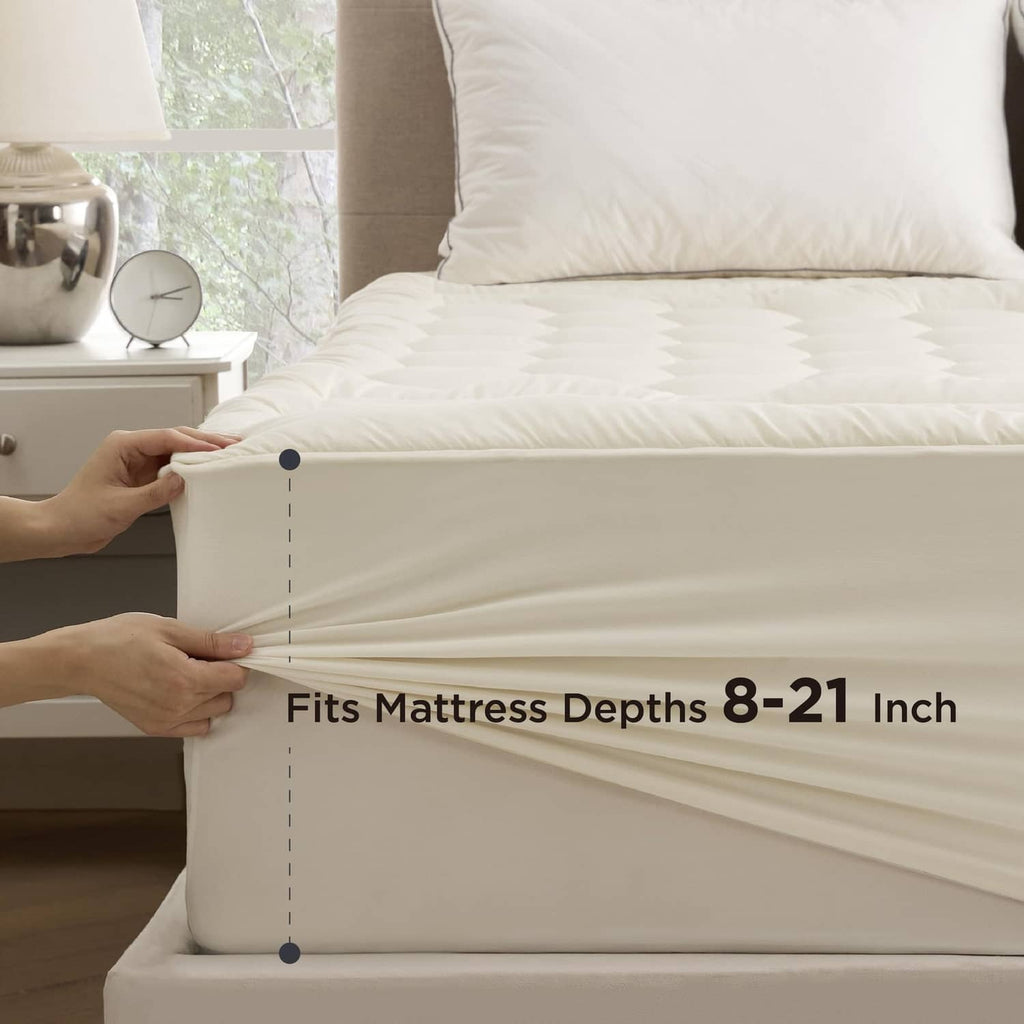 Fitted mattress pad skirt along the mattress edge, light beige