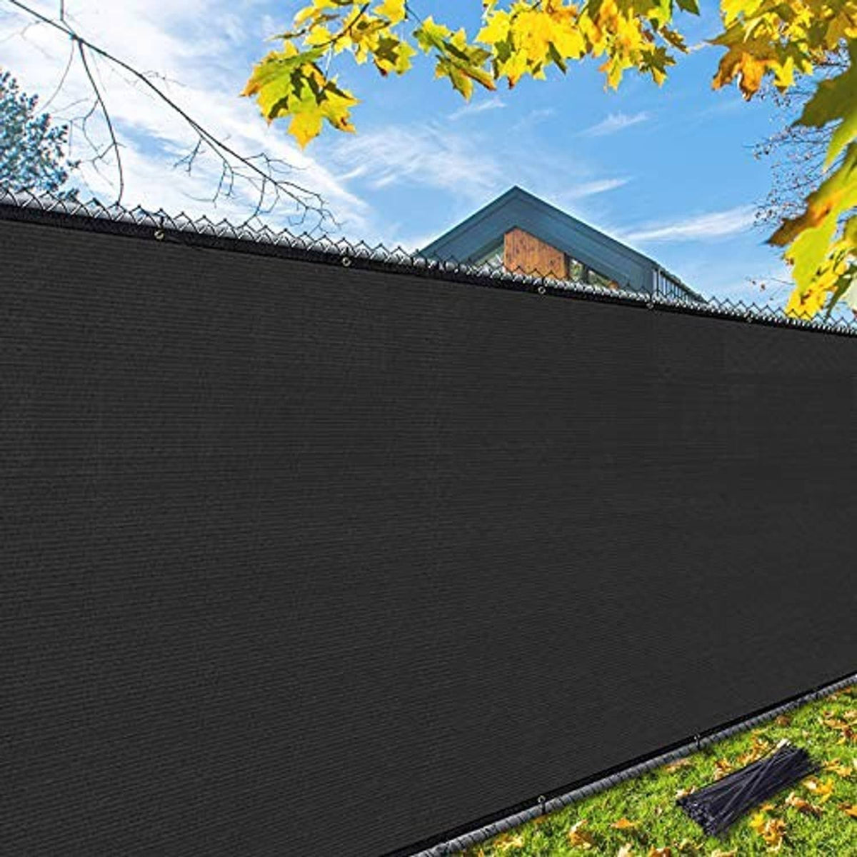 Black outdoor privacy screen fence close-up with mesh texture and stitched hem
