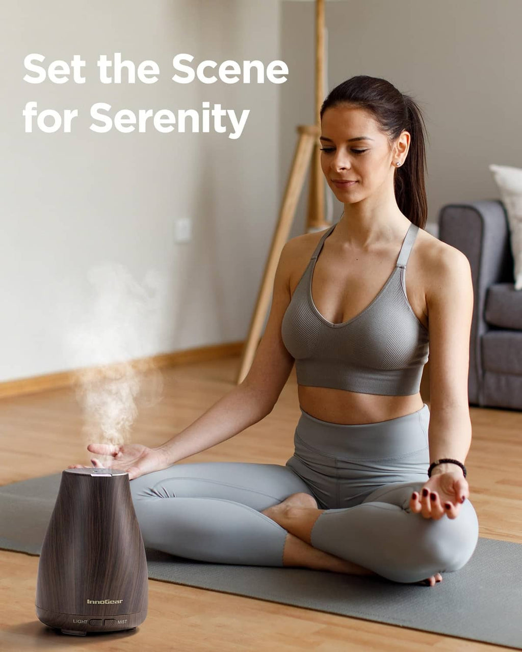 Brown ultrasonic essential oil diffuser releasing mist near an indoor mat
