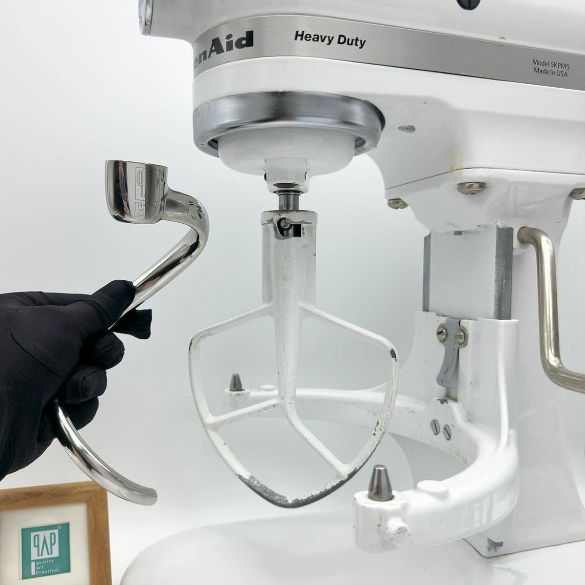 Stainless steel dough hook attachment with bowl-lift mount, close-up