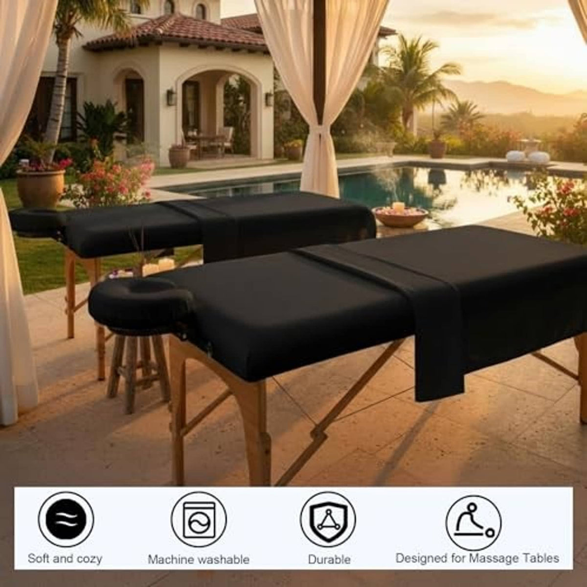 Black massage table sheet set on a wooden table outdoors near a pool