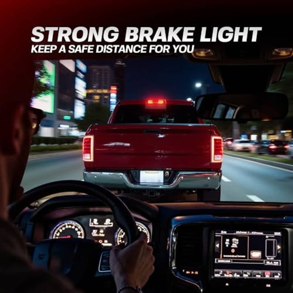 LED third brake light glowing red on pickup rear during nighttime driving