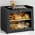 Black two-tier bread box with open front and wooden shelves holding assorted loaves