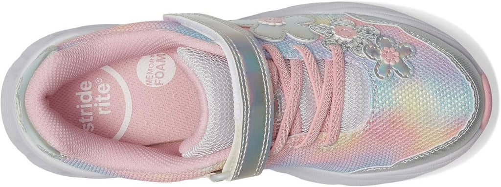Kids sneaker close-up: pink lining, pink laces, iridescent rainbow knit upper, stitching details.