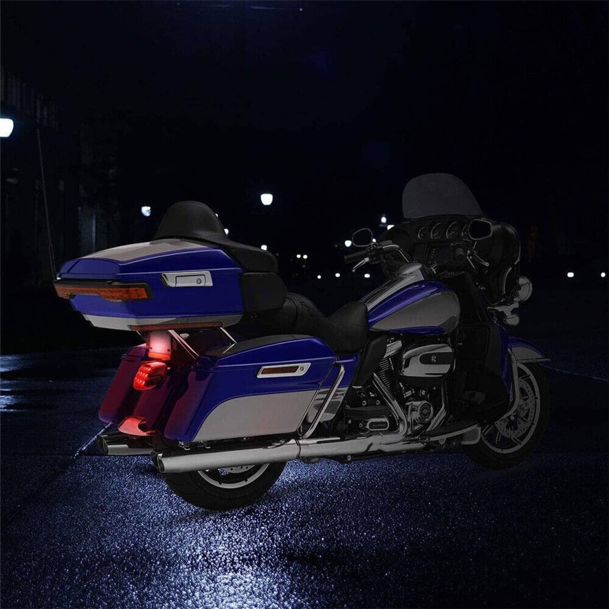 Motorcycle at night with illuminated LED tail brake light and smoked lens