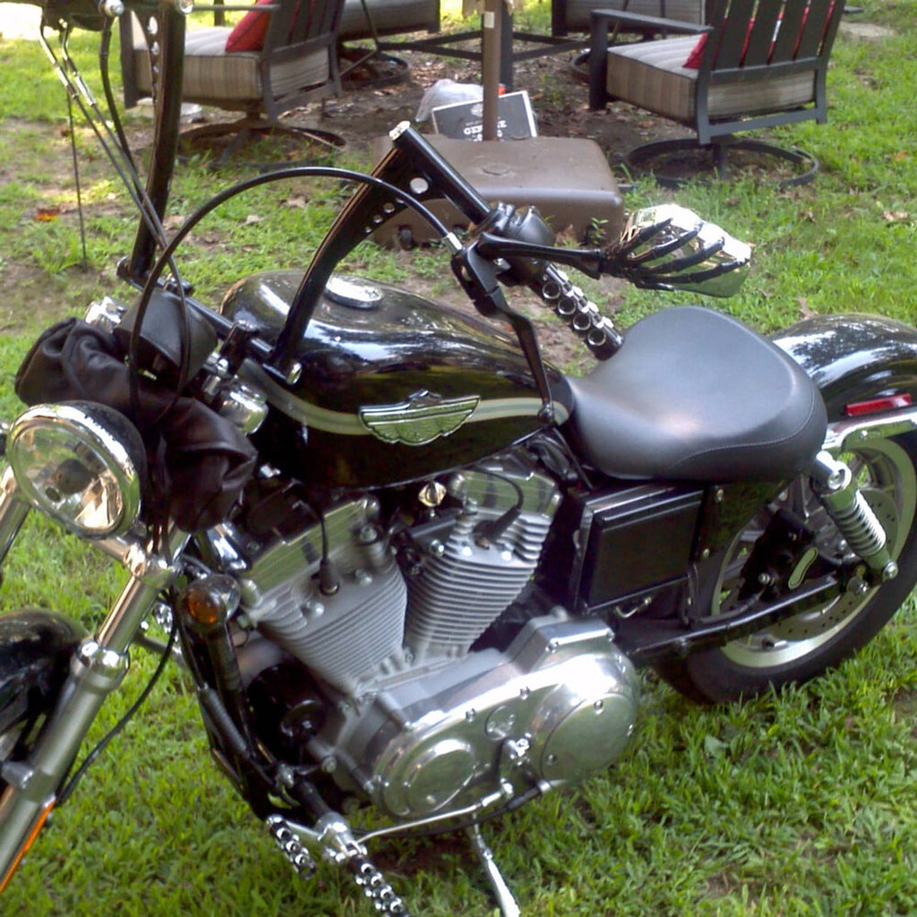 Black solo driver motorcycle seat mounted on a cruiser-style bike