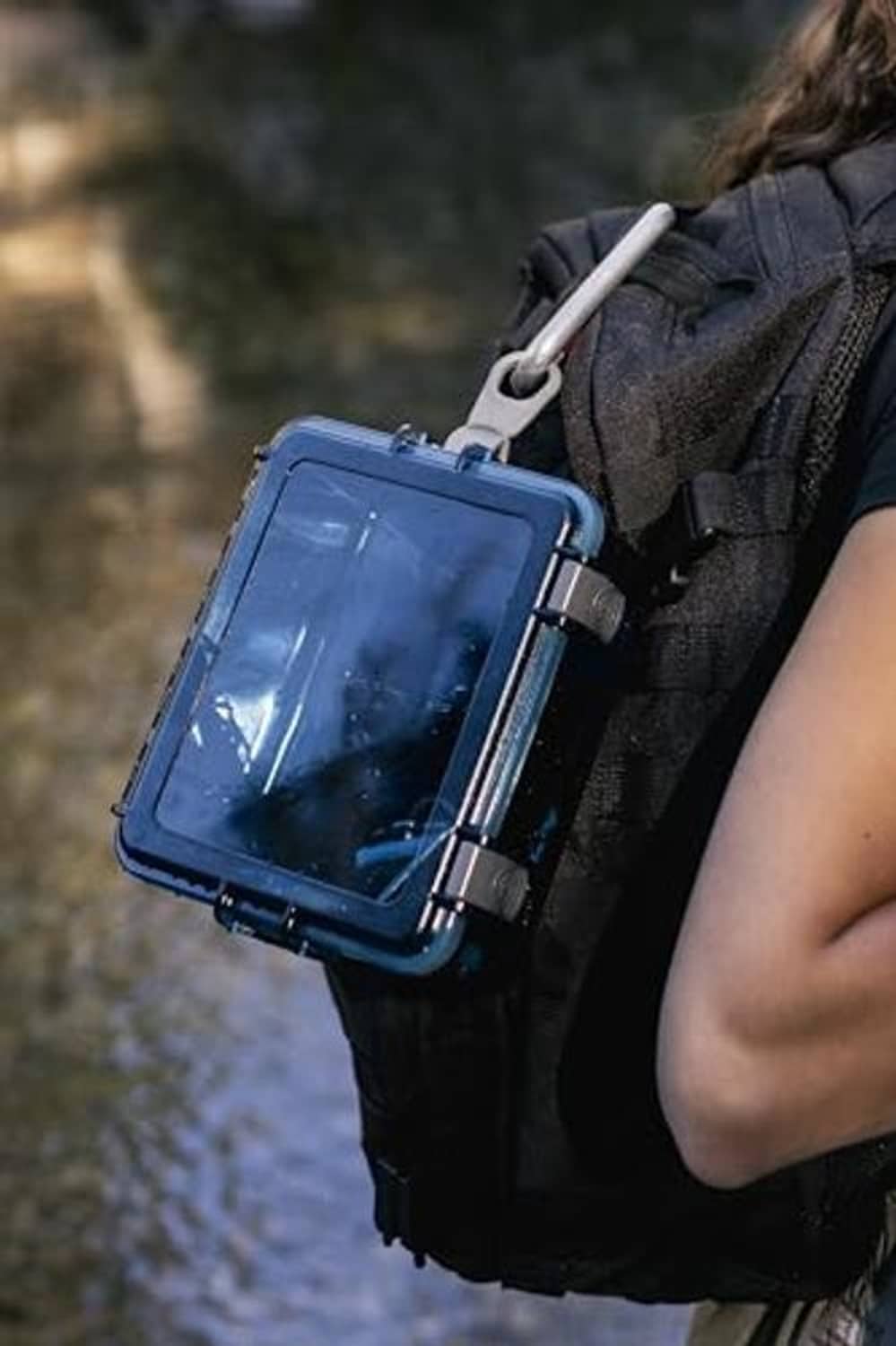 Blue watertight box on backpack strap with clear front window and sealed lid