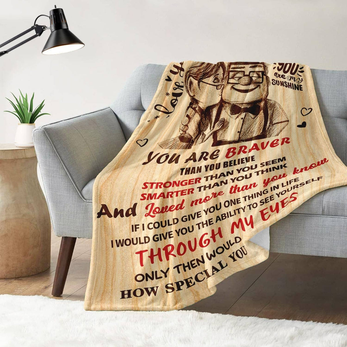 To My Wife throw blanket on a couch with “You are braver” and “You are my sunshine” text