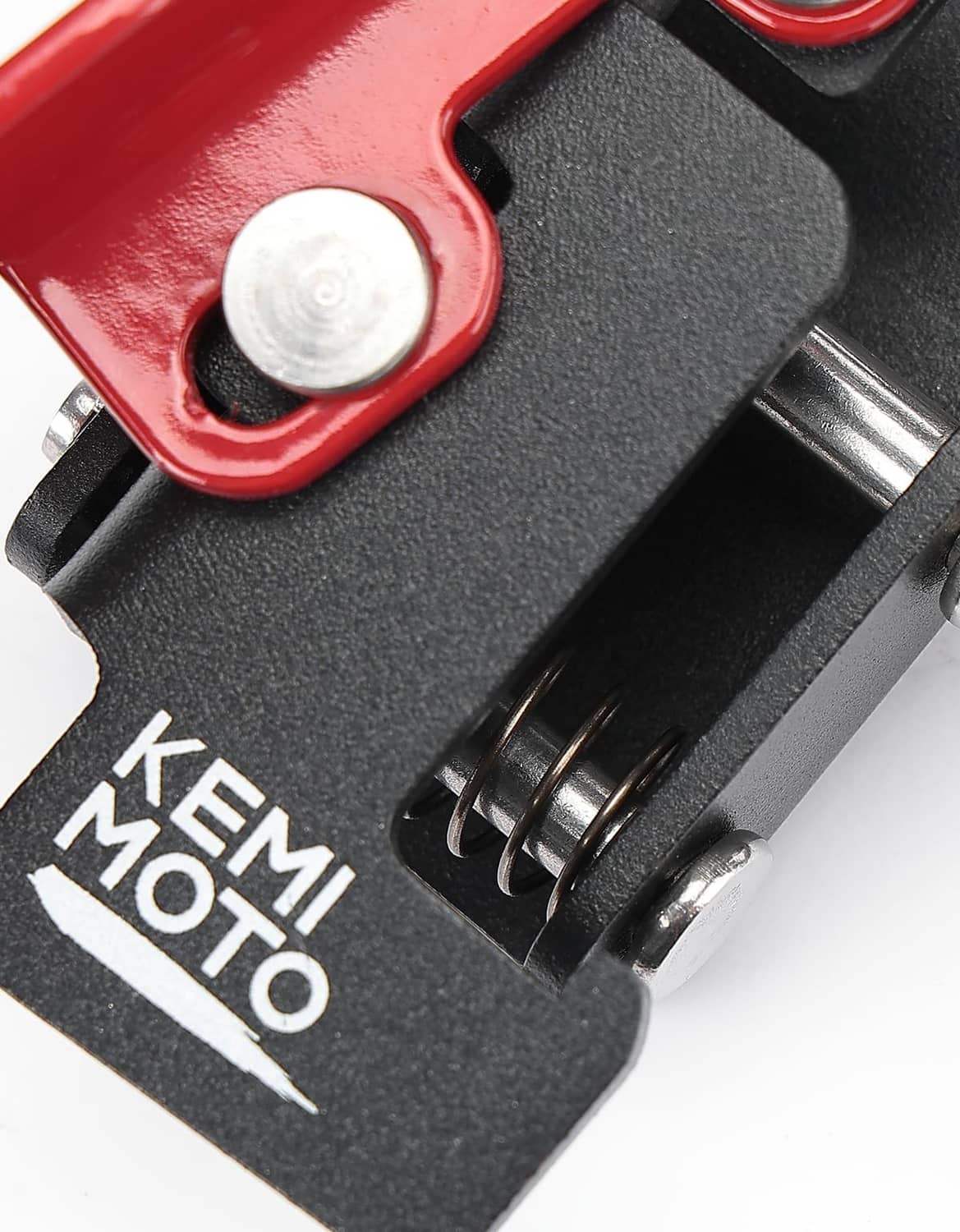 Close-up of parking brake spring guard and label on black and red lever, KEMIMOTO.