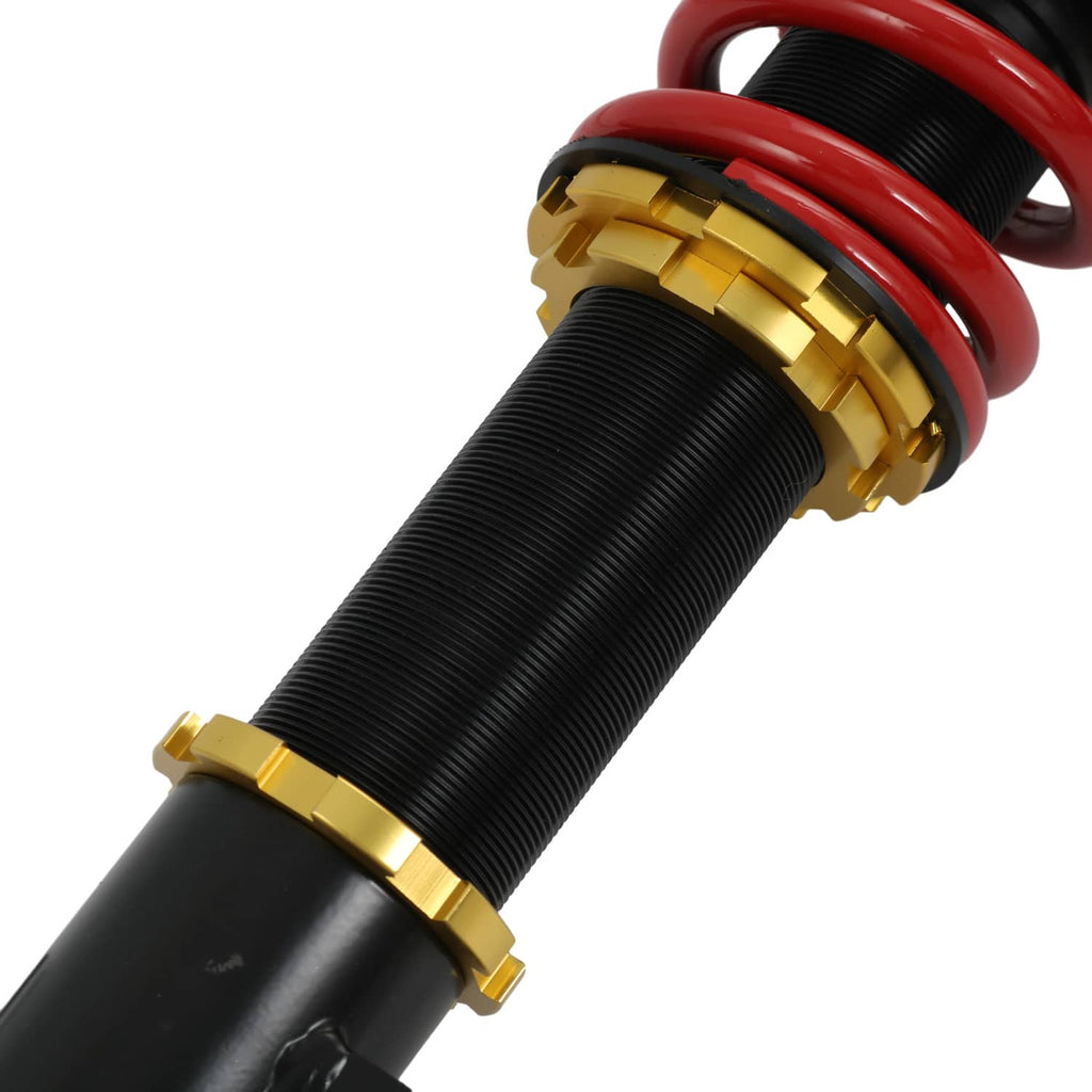 Coilover strut with red spring, black body, and gold bushing rings