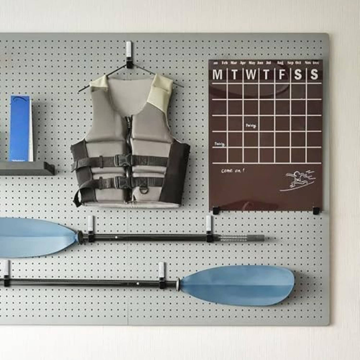 Steel garage hooks with black anti-slip PVC grips on pegboard for tools