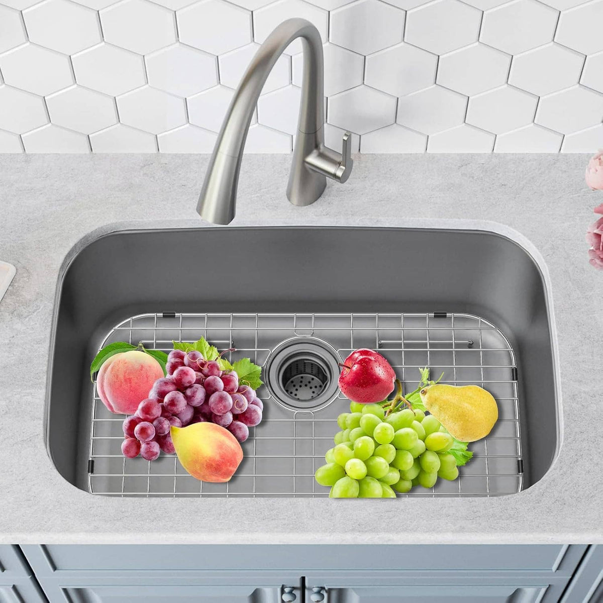 Stainless steel sink protector grid in a sink, holding grapes and fruit