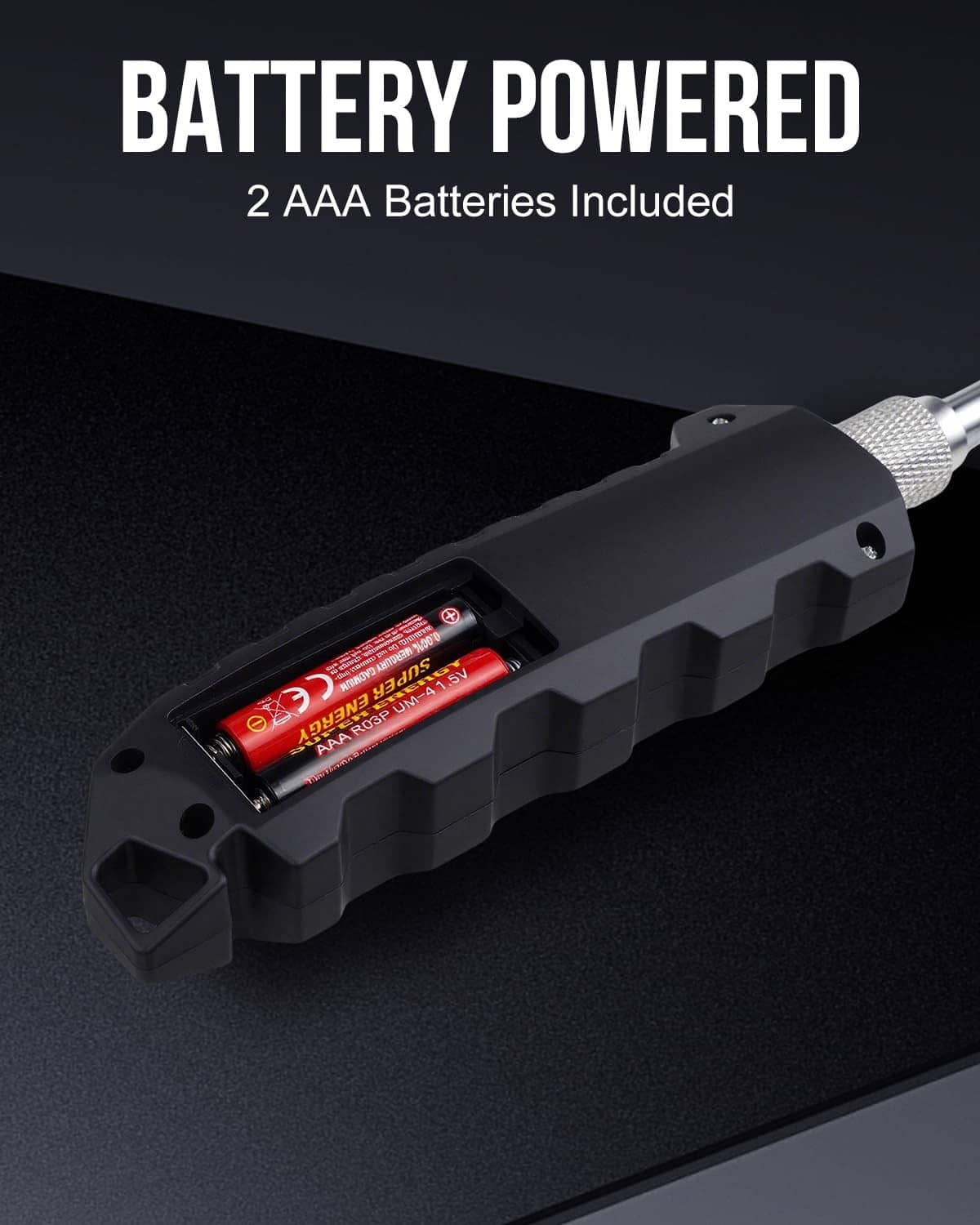 Black tire pressure gauge with battery compartment showing two AAA batteries