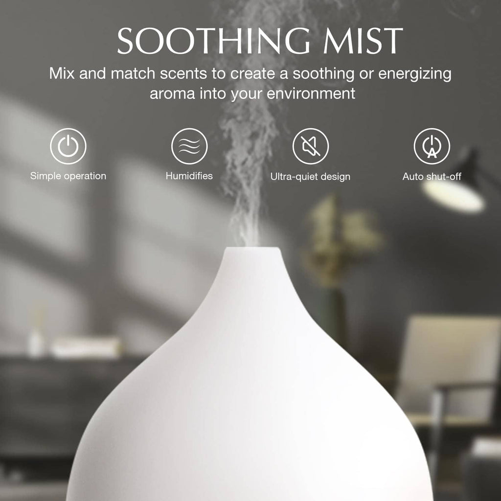 Ultrasonic essential oil diffuser emitting mist, with white top